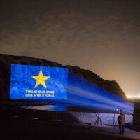 Projection of the EU flag with the caption "This is our star, look after it for us" on the White Cliffs of Dover